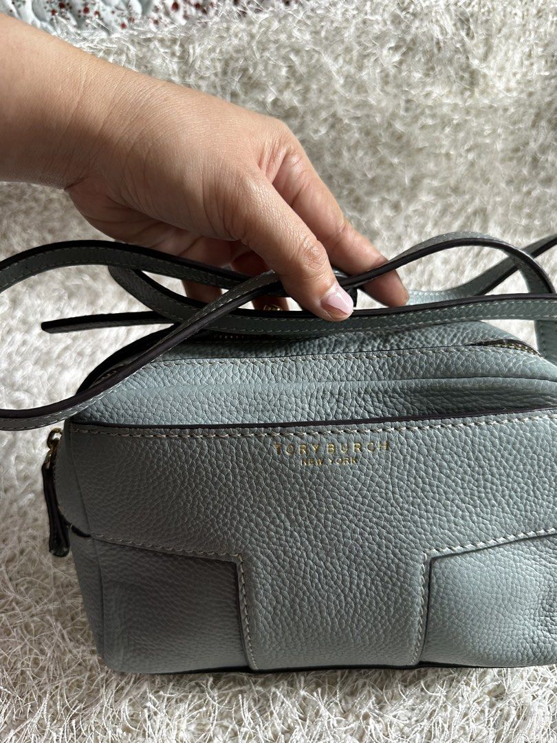Tory Burch Leather Crossbody Bag Light Blue (Category: Cross-body Bags) located in Manila. Submitted by aisasalvad24335 (Listing ID 1465801785, Image 1). Description: - Brand: Tory Burch - Material: Soft light blue pebbled leather - Hardware: Gold-tone - Compartments: Double zippered compartments with clean fabric lining - Strap: Adjustable leather shoulder strap with a small metal logo detail - Condition: Well-maintained, clean interior and exte