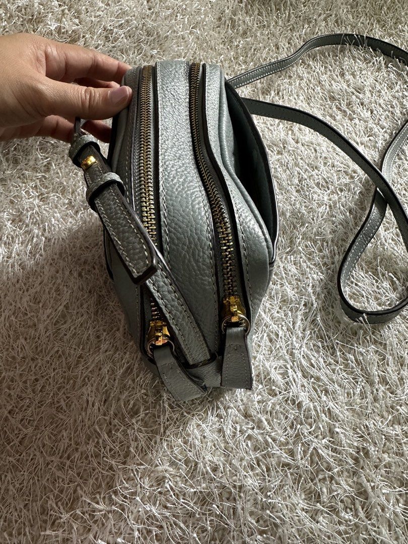 Tory Burch Leather Crossbody Bag Light Blue (Category: Cross-body Bags) located in Manila. Submitted by aisasalvad24335 (Listing ID 1465801785, Image 2). Description: - Brand: Tory Burch - Material: Soft light blue pebbled leather - Hardware: Gold-tone - Compartments: Double zippered compartments with clean fabric lining - Strap: Adjustable leather shoulder strap with a small metal logo detail - Condition: Well-maintained, clean interior and exte