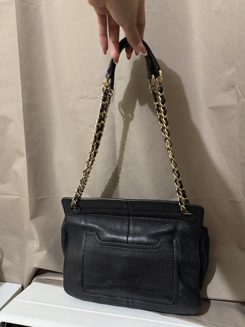 Tory Burch Marion shoulder bag (Category: Luxury Bags & Wallets) located in Quezon City. Submitted by declutterbycy (Listing ID 1465832753, Image 3). Description: - Brand: Tory Burch - Color/Material: Black leather with gold hardware - Strap: Interwoven chain and leather shoulder strap - Closure: Flap with magnetic snap button - Exterior: Embossed logo on front, whipstitch edge details, and back slip pocket - Interior: Monogram print fabric linin