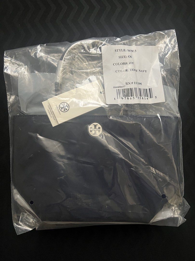 Tory Burch Navy Mini Nylon Tote Bag (Category: Tote Bags) located in Pasay City. Submitted by himebrat1108 (Listing ID 1465826155, Image 3). Description: - Brand: Tory Burch - Style: Nylon Tote (Style #167913, Size: OS) - Color: Tory Navy - Condition: Brand new, never used, still in original plastic packaging with store tags attached - Inclusions: Dust bag and detachable shoulder strap.