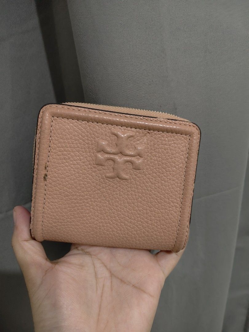 Tory Burch pink leather bi-fold wallet (Category: Luxury Bags & Wallets) located in Mandaluyong City. Submitted by declutterpreloved2.0 (Listing ID 1465818367, Image 3). Description: - Brand: Tory Burch - Material: Pink pebbled leather with gold-tone hardware - Closure: Snap closure for the main compartment, zipper for the coin pocket - Interior: Multiple card slots and cash compartments - Exterior: Debossed logo on front flap and a zippered coin