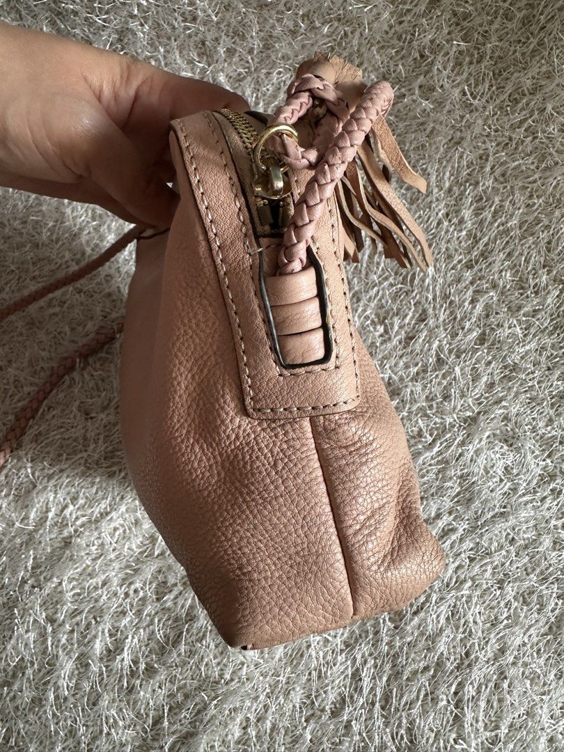 Tory Burch Pink Leather Crossbody Bag (Category: Luxury Bags & Wallets) located in Manila. Submitted by aisasalvad24335 (Listing ID 1465801410, Image 2). Description: - Brand: Tory Burch - Material: Soft pink pebbled leather with gold-tone hardware - Design: Stylish braided shoulder strap and playful side tassel accents - Closure: Top zip closure - Interior: Pink logo-print fabric lining featuring one zip pocket and one slip pocket - Size: Compac