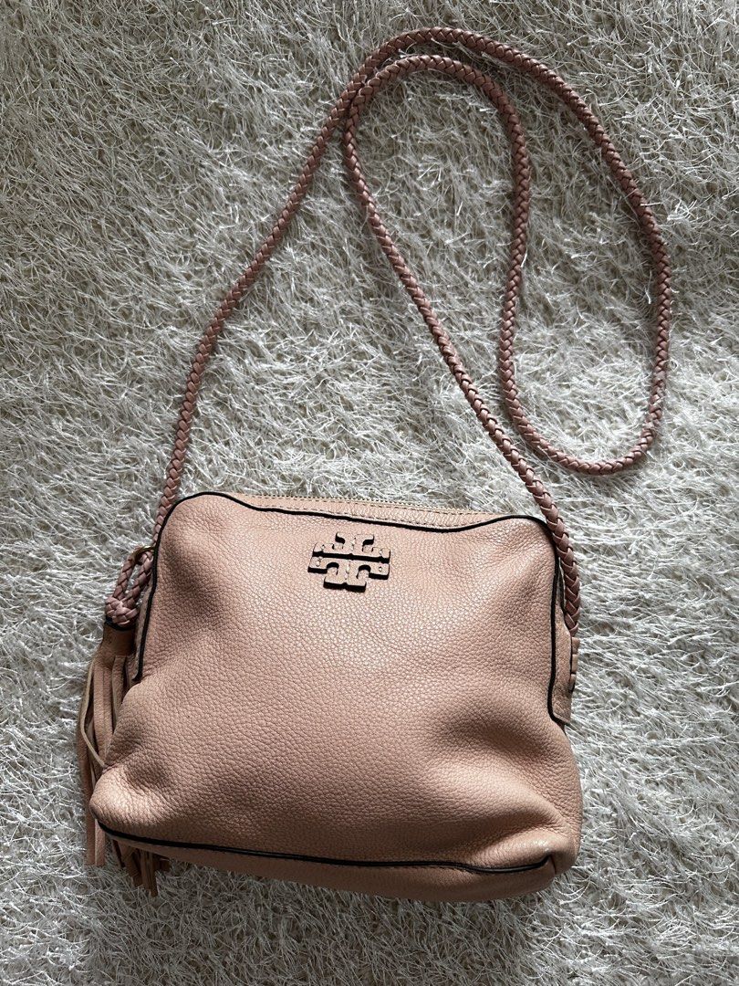 Tory Burch Pink Leather Crossbody Bag (Category: Luxury Bags & Wallets) located in Manila. Submitted by aisasalvad24335 (Listing ID 1465801410, Image 1). Description: - Brand: Tory Burch - Material: Soft pink pebbled leather with gold-tone hardware - Design: Stylish braided shoulder strap and playful side tassel accents - Closure: Top zip closure - Interior: Pink logo-print fabric lining featuring one zip pocket and one slip pocket - Size: Compac