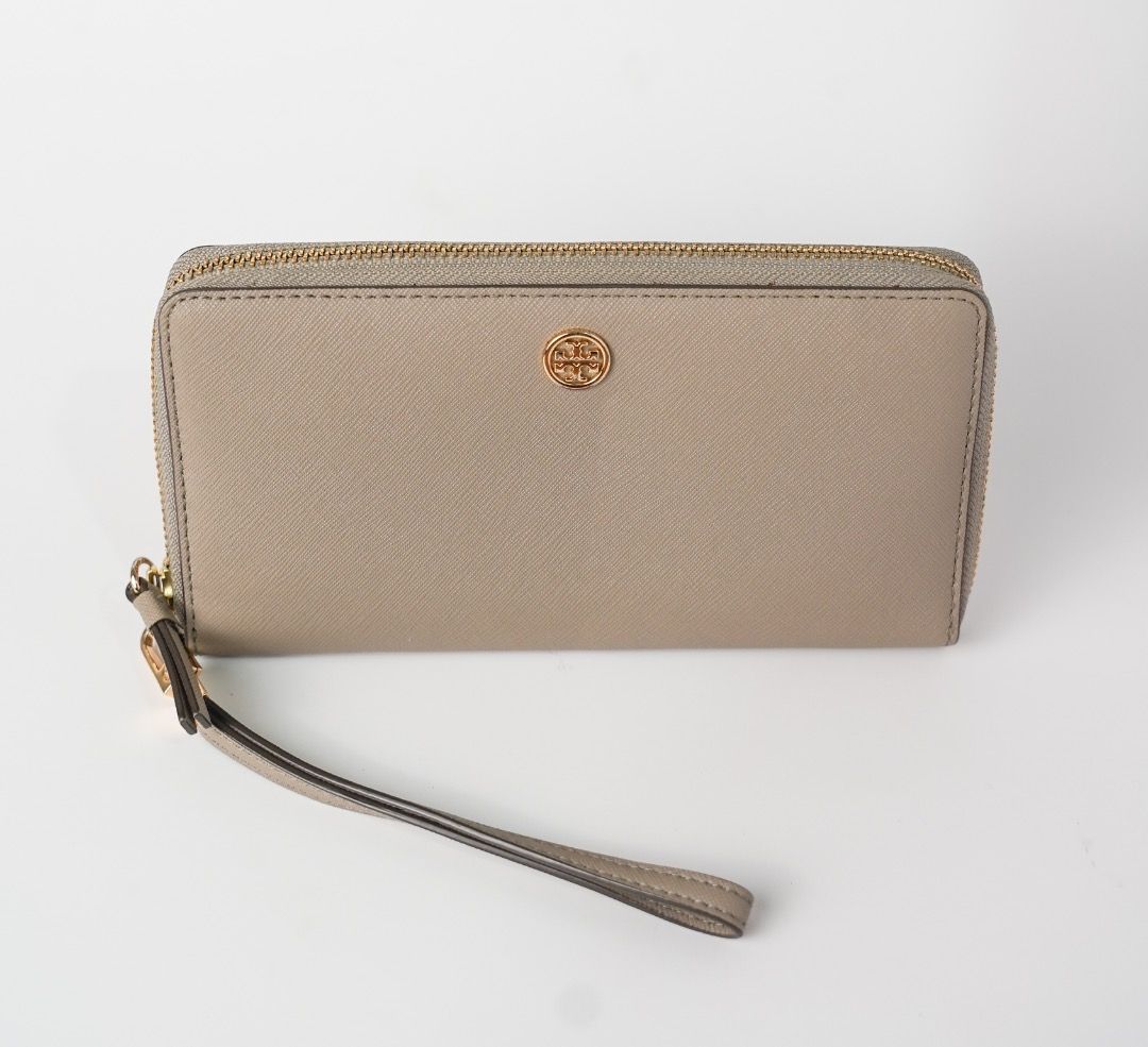Tory Burch Saffiano Leather Wristlet Wallet Grey (Category: Luxury Bags & Wallets) located in Pasig City. Submitted by laagn.ph (Listing ID 1465764290, Image 3). Description: - Brand: Tory Burch - Material: Premium Saffiano leather in versatile grey - Hardware: Gold-tone with iconic front logo plaque - Features: Secure zip-around closure and matching detachable wrist strap - Interior: Standard size with plenty of slots for cards and cash - Condit