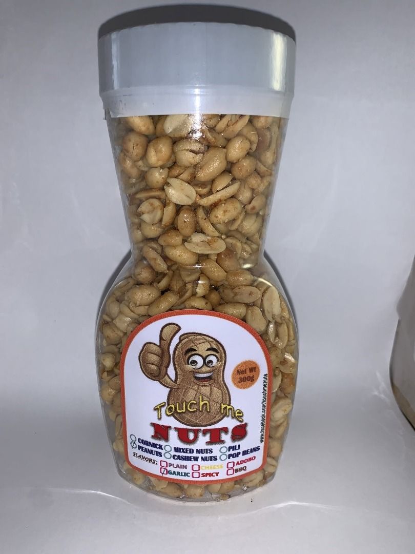 Touch Me Nuts Snack Bottle 300g (Category: Local Eats) located in Malabon City. Submitted by zorlone (Listing ID 1465797698, Image 2). Description: - Net weight: 300 grams of crunchy peanuts - Packaging: Clear hourglass-shaped plastic bottle with a secure white screw-on cap - Label design: Features a funny cartoon peanut mascot giving a thumbs up and flavor checkboxes - Perfect for: Movie nights, barkada tambay, or sharing with family and friends
