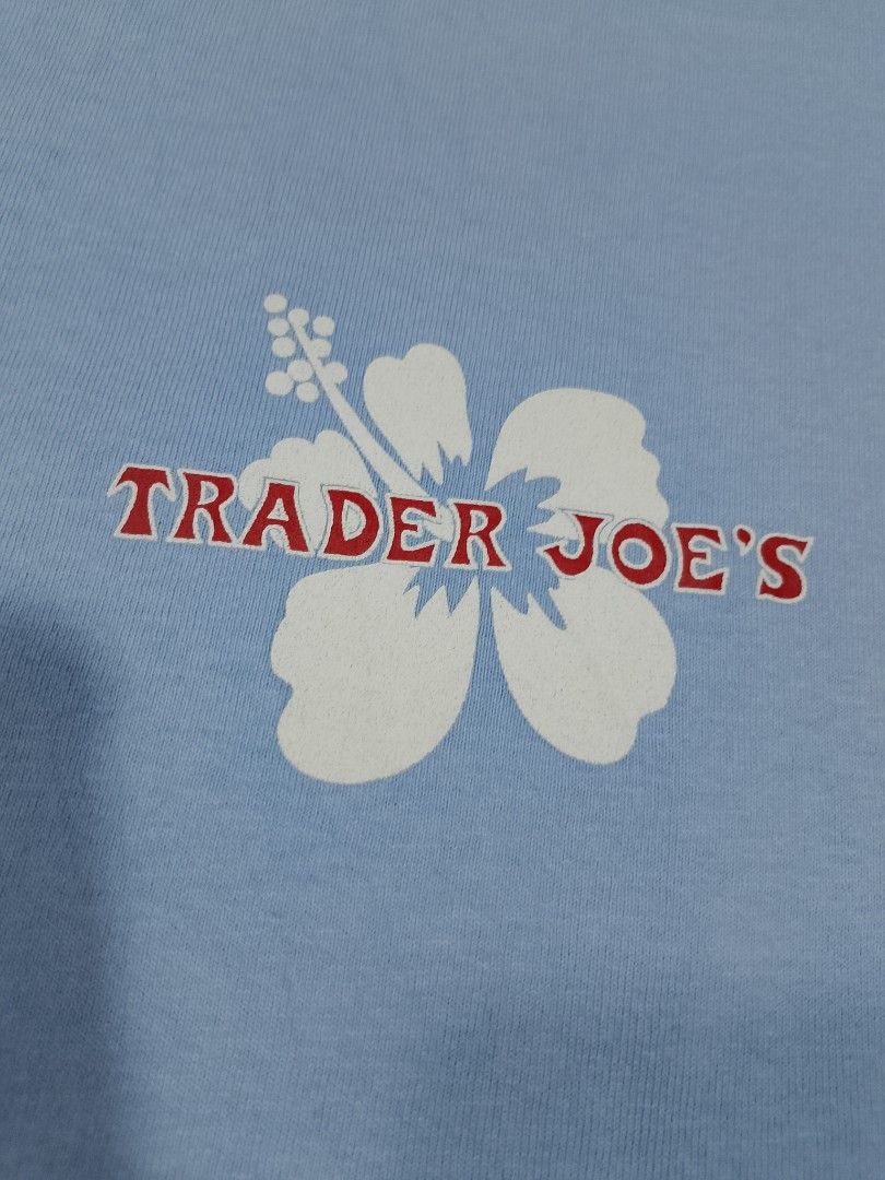 Trader Joe's Hibiscus Logo Uniform Graphic Tee - Blue (Category: Tshirts & Polo Shirts ) located in Cadiz. Submitted by comradstuff (Listing ID 1465952113, Image 2). Description: Trader Joe's Hibiscus Logo Uniform Graphic Tee - Blue w 20 l 28.