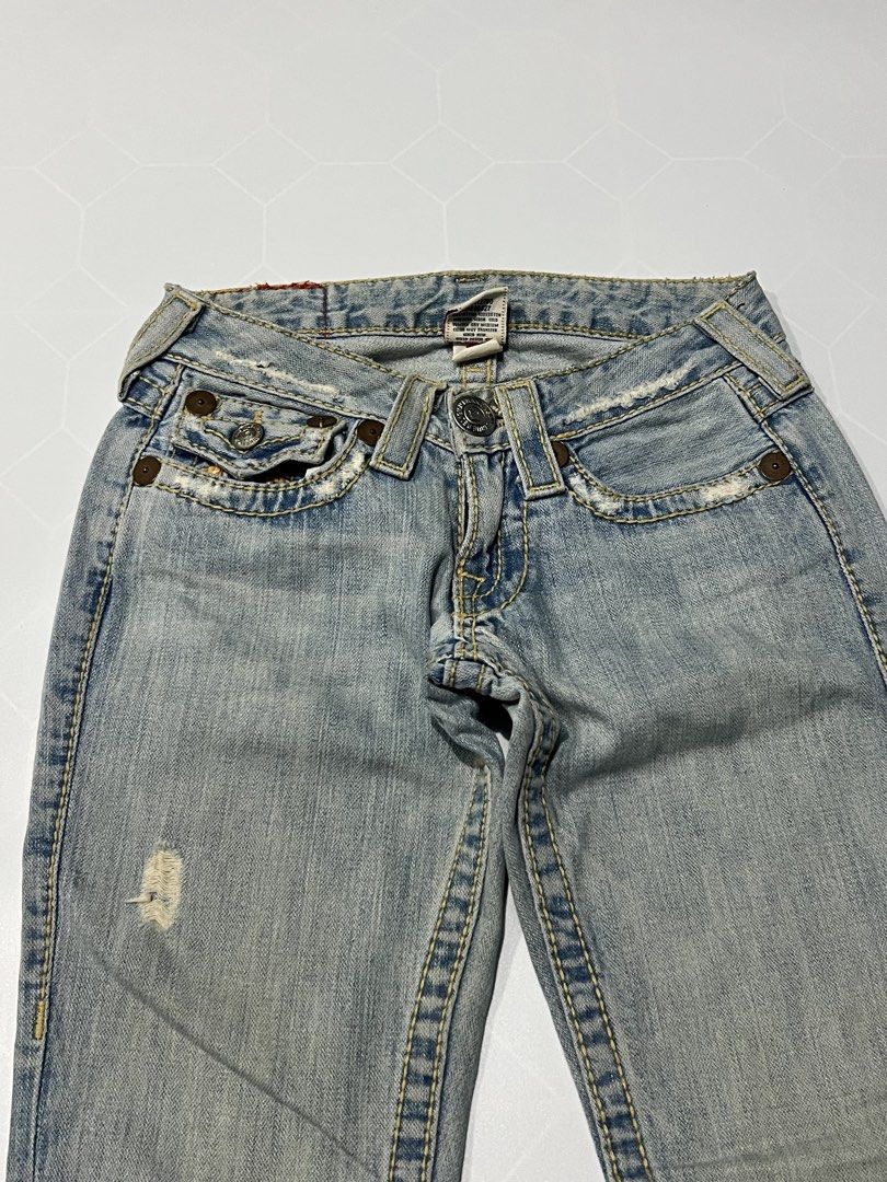 True Religion Flared Denim Jeans Distressed (Category: Jeans) located in Caloocan City. Submitted by lostarchive_55 (Listing ID 1465919823, Image 3). Description: - Brand: True Religion - Wash: Light blue - Cut: Flare leg with mid-rise fit - Details: Distinctive contrast stitching, back flap pockets, and trendy distressed/frayed edges - Closure: Button - Authenticity: RN 112790 on interior tag - Style: Perfect Y2K aesthetic.