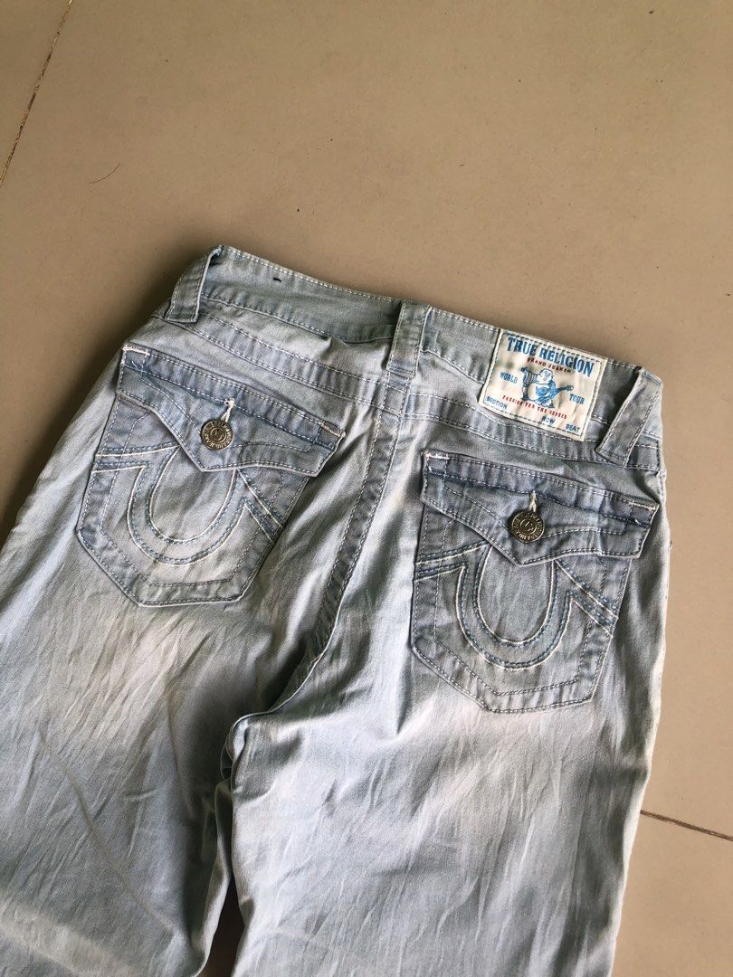 True Religion Light Wash Denim Jeans (Category: Jeans) located in Cagayan de Oro. Submitted by leklekthrift (Listing ID 1465889449, Image 3). Description: - Brand: True Religion - Style: Light wash faded denim with a flared leg cut - Size: 25 (Cotton & polyester blend) - Pockets: Front and back pockets with secure flap button closures - Details: Signature horseshoe stitching on back pockets, classic brand logo patch, and custom inner lining - Con