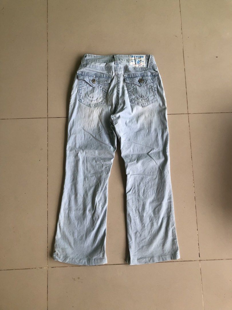 True Religion Light Wash Denim Jeans (Category: Jeans) located in Cagayan de Oro. Submitted by leklekthrift (Listing ID 1465889449, Image 1). Description: - Brand: True Religion - Style: Light wash faded denim with a flared leg cut - Size: 25 (Cotton & polyester blend) - Pockets: Front and back pockets with secure flap button closures - Details: Signature horseshoe stitching on back pockets, classic brand logo patch, and custom inner lining - Con