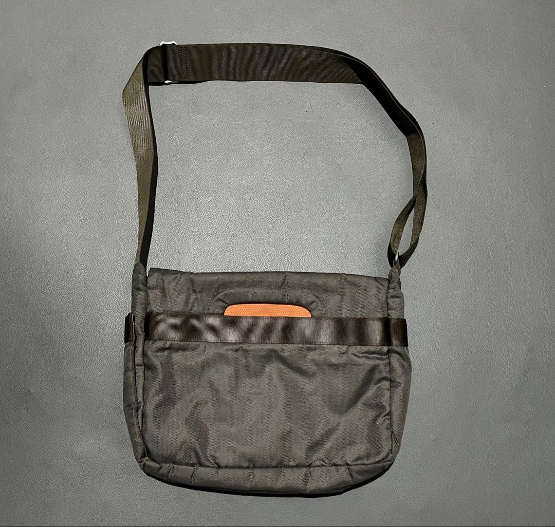 T-Tech Tumi Messenger Bag Dark Green Orange Interior (Category: Sling Bags) located in General Santos City (Dadiangas). Submitted by thiftnibadi3 (Listing ID 1465882374, Image 2). Description: Dark green T-Tech by Tumi messenger bag. Bright orange inner lining with lots of interior slip pockets, pen holders, and zipped compartments. Front flap secures with a plastic buckle clip. Exterior includes an open pocket under the flap and a rear sleeve po