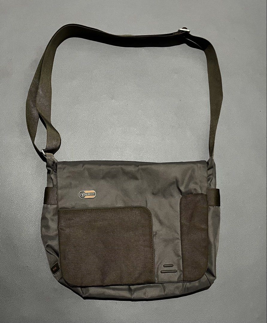 T-Tech Tumi Messenger Bag Dark Green Orange Interior (Category: Sling Bags) located in General Santos City (Dadiangas). Submitted by thiftnibadi3 (Listing ID 1465882374, Image 1). Description: Dark green T-Tech by Tumi messenger bag. Bright orange inner lining with lots of interior slip pockets, pen holders, and zipped compartments. Front flap secures with a plastic buckle clip. Exterior includes an open pocket under the flap and a rear sleeve po