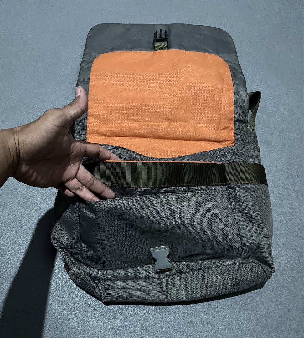 T-Tech Tumi Messenger Bag Dark Green Orange Interior (Category: Sling Bags) located in General Santos City (Dadiangas). Submitted by thiftnibadi3 (Listing ID 1465882374, Image 3). Description: Dark green T-Tech by Tumi messenger bag. Bright orange inner lining with lots of interior slip pockets, pen holders, and zipped compartments. Front flap secures with a plastic buckle clip. Exterior includes an open pocket under the flap and a rear sleeve po