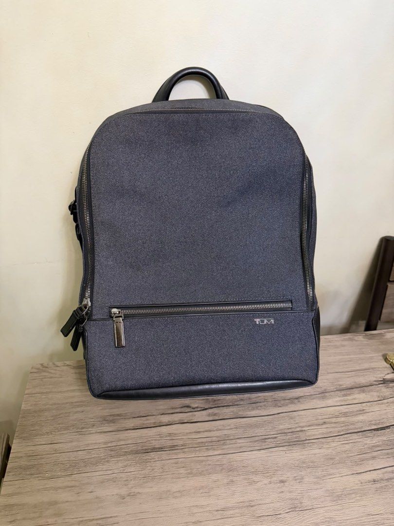 TUMI Harrison Grey Backpack (Category: Backpacks) located in Manila. Submitted by jonkakkee (Listing ID 1465846640, Image 1). Description: - Authentic Tumi backpack in dark grey textured fabric - Premium black leather trim on the bottom and top handle - Secure double zip main compartment & front zip pocket with logo plate - Includes side luggage tag & Tumi Tracer metal plate with barcode - Comfortable, padded, and adjustable back straps - Clean i