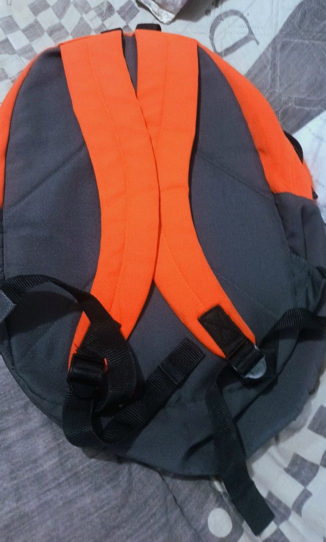 Umbro Orange And Grey Backpack (Category: Backpacks) located in Manila. Submitted by japalopy406 (Listing ID 1465868659, Image 2). Description: - Eye-catching bright orange and dark grey colorway - Front zippered pocket featuring the iconic Umbro logo - Spacious main compartment with secure zipper closure - Adjustable black shoulder straps with sturdy plastic buckles - Convenient top grab handle for easy carrying - Durable fabric construction, pe