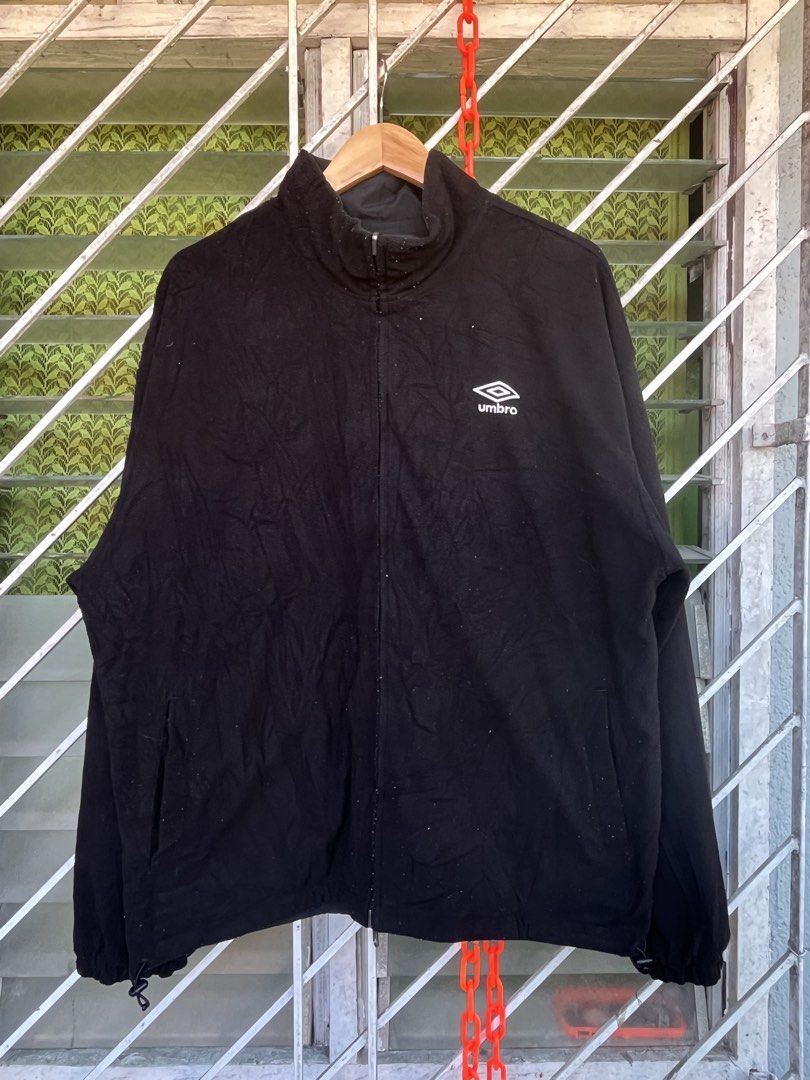 Umbro Reversible Black and Grey Jacket (Category: Coats, Jackets and Outerwear) located in Pilar. Submitted by fast-flip-ni-miko. (Listing ID 1465825176, Image 3). Description: - Brand: Umbro - Style: Reversible full-zip jacket - Colorway: Black and grey - Materials: Durable nylon on one side, soft black fleece on the other - Features: High collar, front pockets, and branded zipper pull tab - Fit: Regular fit, great for everyday wear and layering