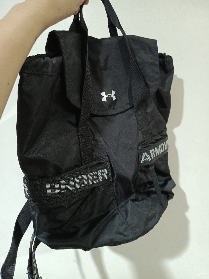 Under Armour Black Flap Backpack with Branded Straps (Category: Backpacks) located in Quezon City. Submitted by mhiemime (Listing ID 1465797875, Image 2). Description: - Brand: Under Armour - Color: Classic Black - Dimensions: Approx. 35.6 x 25.2 x 16 cm - Closure: Flap top with secure drawstring main compartment - Features: Convenient top carry handles, branded webbing on front and straps, clean interior lining with internal pockets - Capacity: 
