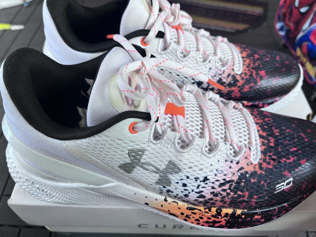 Under Armour Curry 2 Low Flotro NM (Category: Sneakers) located in Manila. Submitted by jcloyd (Listing ID 1465768617, Image 3). Description: - Model: Under Armour Curry 2 Low Flotro NM - Size: Men's 11 / Women's 12.5 / EUR 45 - Colorway: White base with black, pink, and orange gradient splatter on the toe box - Performance: Lightweight and grippy Flow technology sole unit - Inclusion: Comes with the original box - Condition: Brand new / pristine