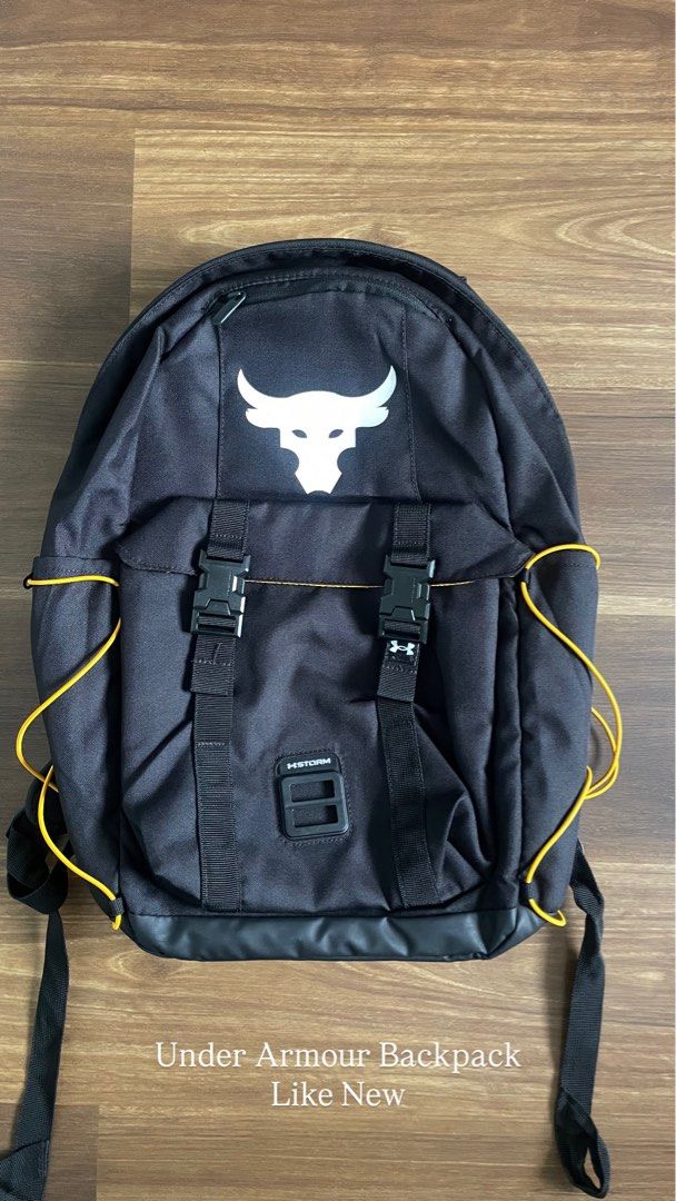 Under Armour Project Rock Brahma Bull Backpack (Category: Backpacks) located in Bacolod City. Submitted by jmcercado (Listing ID 1465925943, Image 1). Description: - Authentic Under Armour Project Rock Backpack - Color: Black with striking white Brahma Bull logo - UA Storm technology delivers an element-battling, highly water-resistant finish - Secure dual buckle closure with adjustable straps for comfort - Stylish yellow cord details on the side