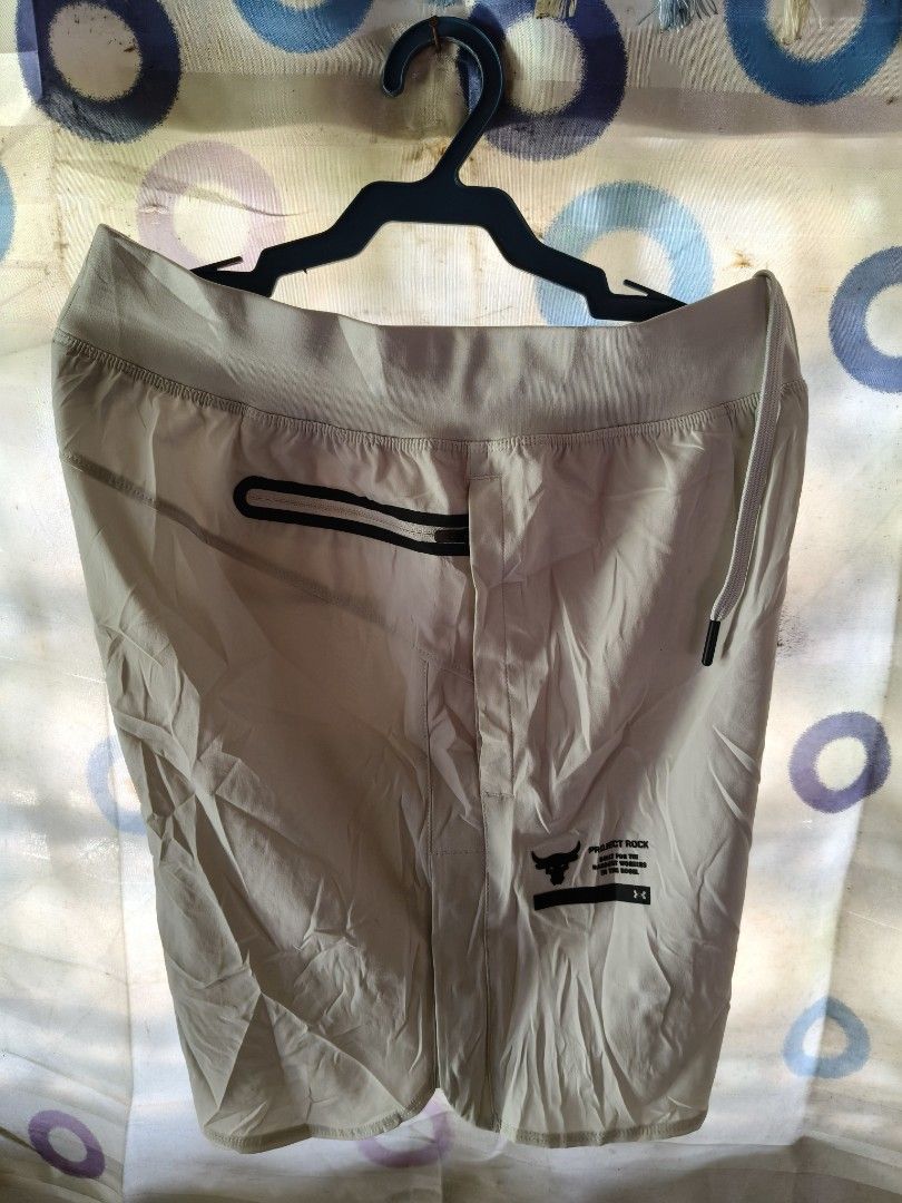 Under Armour Project Rock Workout Shorts White Small (Category: Shorts) located in Compostela. Submitted by johnwilz1144610 (Listing ID 1465765101, Image 2). Description: - Brand: Under Armour Project Rock - Color: white/Cream - Size: Small(29-30waist) - Material: Lightweight performance fabric - Waistband: Adjustable with drawstring - Storage: Secure zippered back pocket and zippered side pockets - Details: Project Rock bull logo and 'Built for 