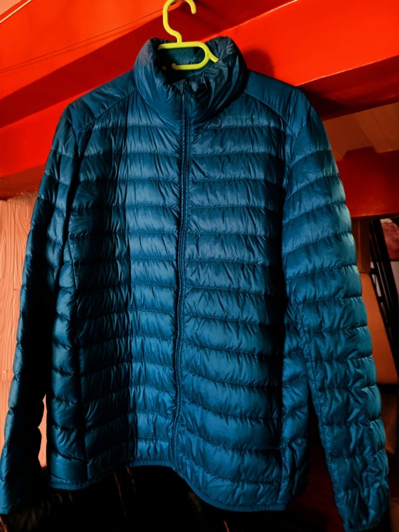 Uniqlo Blue Down Jacket Size L (Category: Coats, Jackets and Outerwear) located in Imus. Submitted by melgibsong24 (Listing ID 1465766852, Image 1). Description: - Brand: Uniqlo - Item: Puffer Jacket - Color: Bright Blue - Size: L - Measurements: ~25 inches across chest (flat lay) - Features: Full zip front, stand-up collar, quilted horizontal stitching, lightweight yet warm - Condition: Clean, ready to wear.