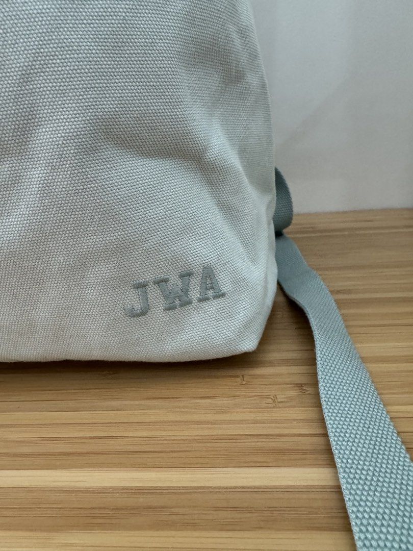 Uniqlo JWA Canvas Backpack (Category: Backpacks) located in Makati City. Submitted by the.archives (Listing ID 1465856744, Image 3). Description: - Color: light teal - Material: durable/ thick canvas - Closure: Buckle securing the rolled top - Comfort: Padded shoulder straps and top carry handle - Detail: Embroidered initials 'JWA, with small pocket inside, with secret zipper on the side for easy access - Condition: Clean fabric with minimal wear