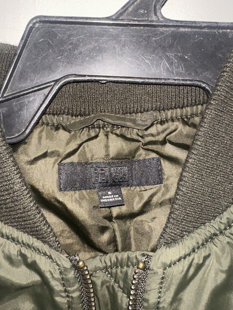 Uniqlo Olive Green Bomber Jacket Size S (Category: Coats, Jackets and Outerwear) located in Makati City. Submitted by biancak20 (Listing ID 1465892973, Image 3). Description: - Brand: Uniqlo - Item: Bomber jacket - Color: Olive green - Size: S (Made in Indonesia) - Condition: Clean, excellent overall - Features: Front zipper closure, ribbed collar, cuffs, and hem, plus two front snap-button pockets - Style: Lightweight and versatile for layering 