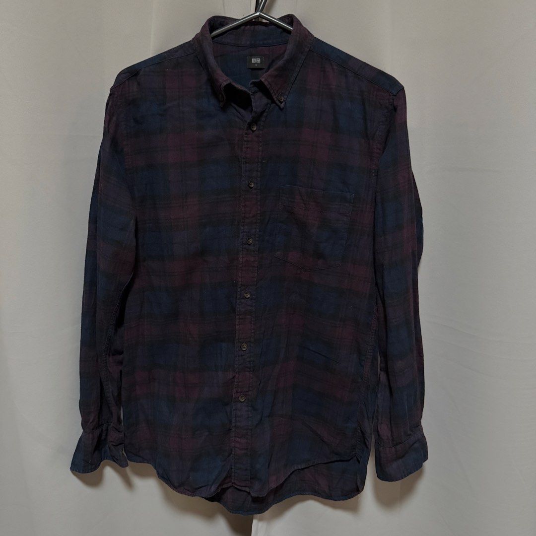 Uniqlo Plaid Long Sleeve Button Down Polo (Category: Longsleeves) located in Makati City. Submitted by heyitsg_ (Listing ID 1465854140, Image 1). Description: - Brand: Uniqlo - Style: Casual long-sleeve flannel button-down shirt - Pattern: Dark purple and blue plaid - Material: 100% Cotton (Made in Vietnam) - Size: Small - Features: Regular collar, front chest pocket, button cuffs - Perfect for easy layering.