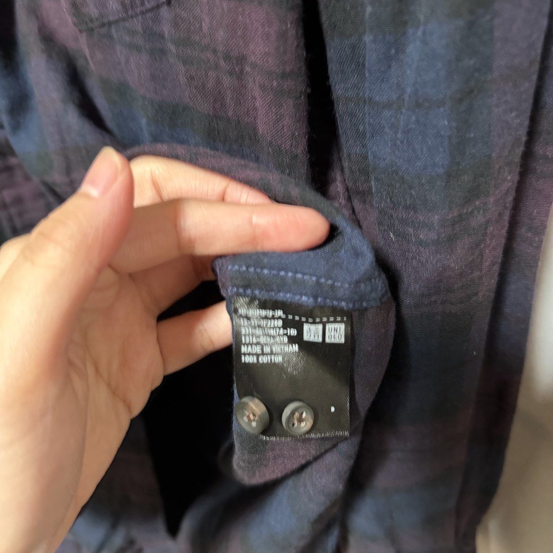 Uniqlo Plaid Long Sleeve Button Down Polo (Category: Longsleeves) located in Makati City. Submitted by heyitsg_ (Listing ID 1465854140, Image 2). Description: - Brand: Uniqlo - Style: Casual long-sleeve flannel button-down shirt - Pattern: Dark purple and blue plaid - Material: 100% Cotton (Made in Vietnam) - Size: Small - Features: Regular collar, front chest pocket, button cuffs - Perfect for easy layering.