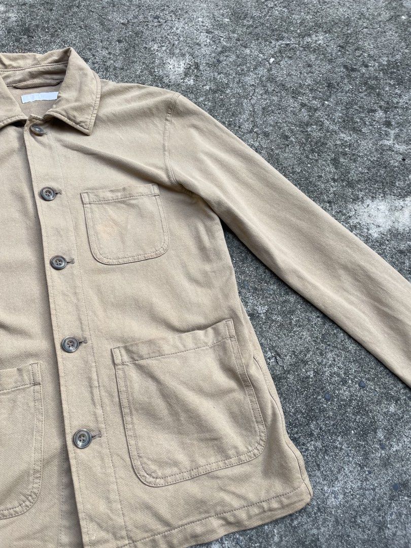 Uniqlo Tan Chore Jacket Workwear Utility Jacket (Category: Coats, Jackets and Outerwear) located in Pasay City. Submitted by qptingz (Listing ID 1465848074, Image 3). Description: - Color: Classic tan - Material: Durable twill fabric - Pockets: Three front patch pockets and one chest pocket - Closure: Front button closure with brown buttons - Fit: Regular collar, fits true to size - Condition: Great transitional layering piece with some light sta