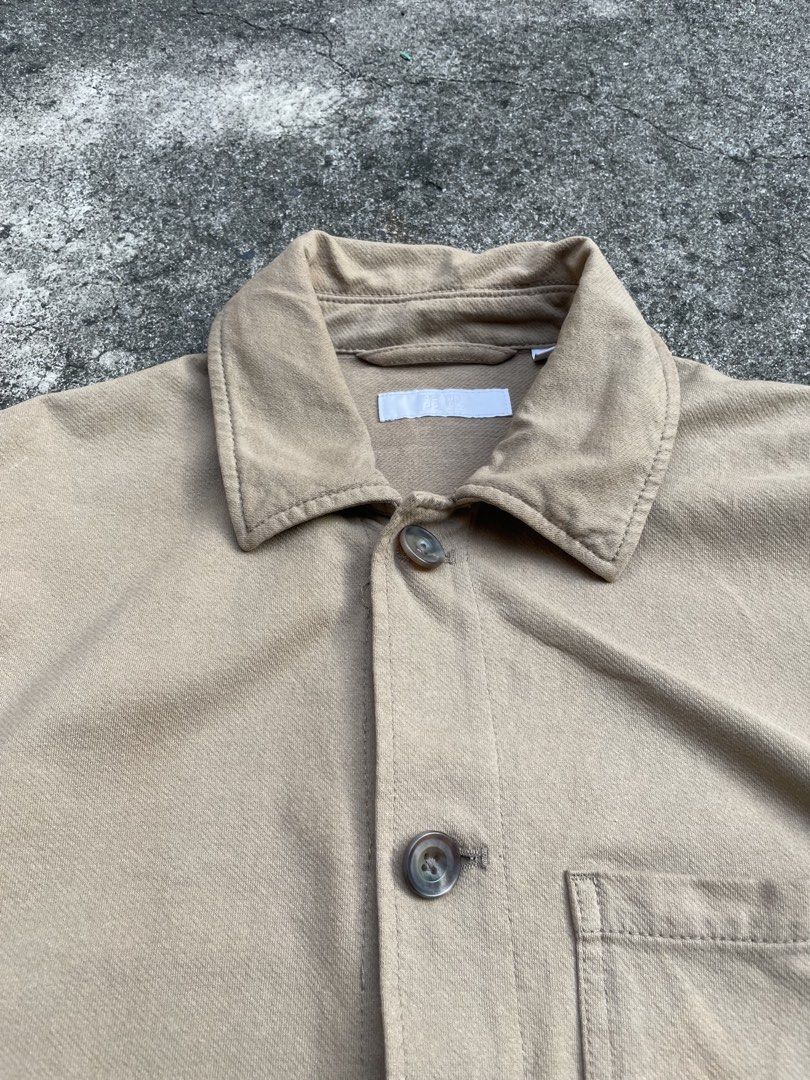 Uniqlo Tan Chore Jacket Workwear Utility Jacket (Category: Coats, Jackets and Outerwear) located in Pasay City. Submitted by qptingz (Listing ID 1465848074, Image 2). Description: - Color: Classic tan - Material: Durable twill fabric - Pockets: Three front patch pockets and one chest pocket - Closure: Front button closure with brown buttons - Fit: Regular collar, fits true to size - Condition: Great transitional layering piece with some light sta