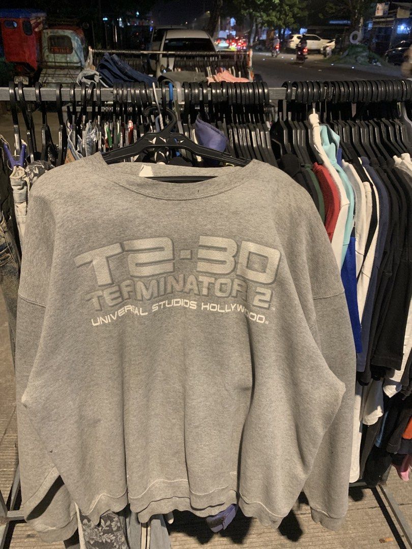 Universal Studios Hollywood Terminator 2 3D Grey Sweatshirt (Category: Coats, Jackets and Outerwear) located in Naga. Submitted by than09070539101 (Listing ID 1465885427, Image 1). Description: - Authentic Universal Studios Hollywood merchandise - Classic Terminator 2 3D large graphic print on the front - Comfortable crewneck style with long sleeves - Cozy soft fleece lining for extra warmth - Durable ribbed cuffs and hem - Official branded neck 