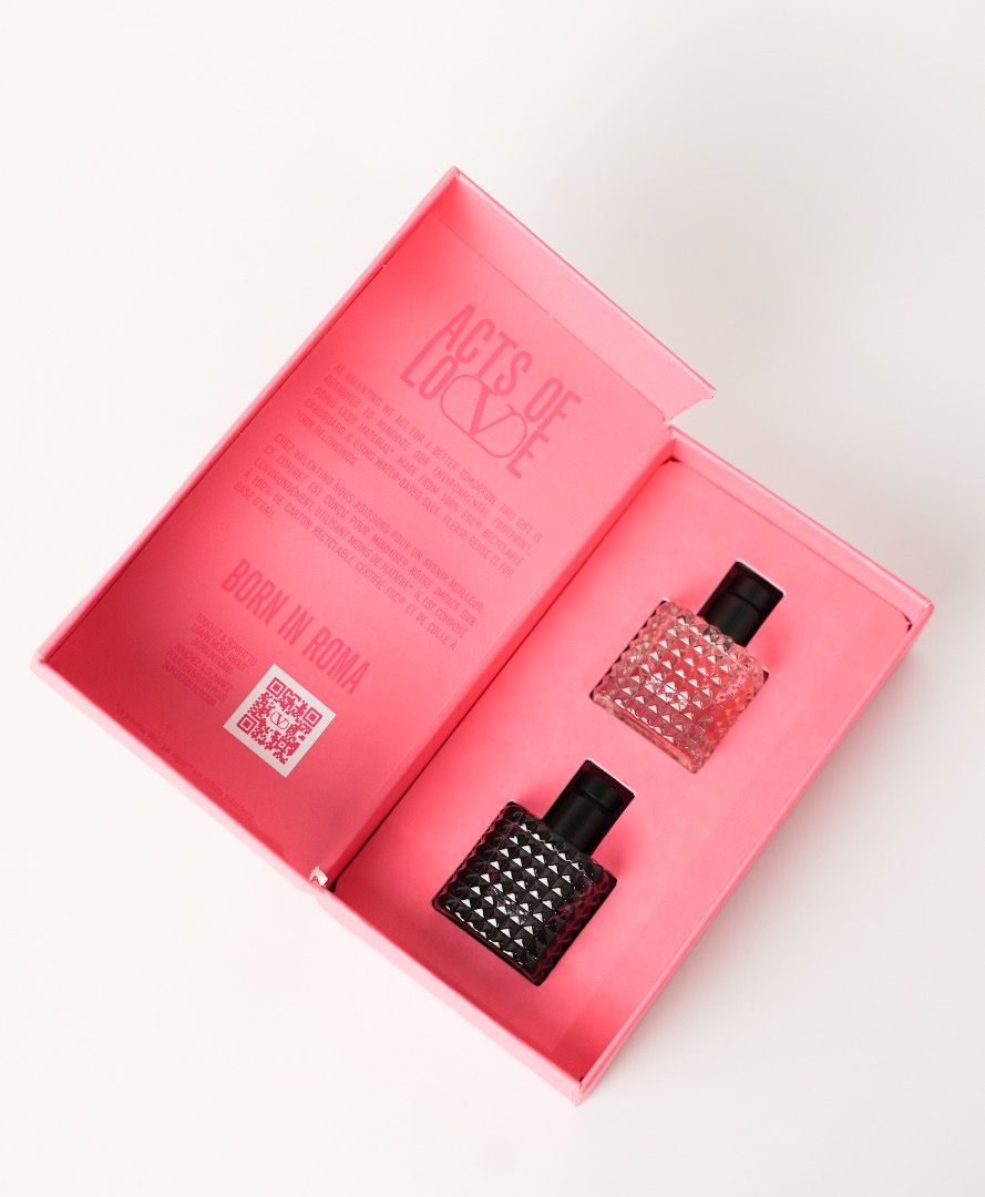 Valentino Mini Duo (Born in Roma) (Category: Fragrance & Deodorants) located in Pasig City. Submitted by laagn.ph (Listing ID 1465763916, Image 3). Description: - Brand: Valentino - Model: Mini Duo (Born in Roma & Born in Roma Intense) - Packaging: Attractive pink gift box with magnetic/fold-open design - Bottles: Two miniature signature studded glass bottles with black caps - Condition: Brand new, pristine item - Perfect for: Gifting, travel, or