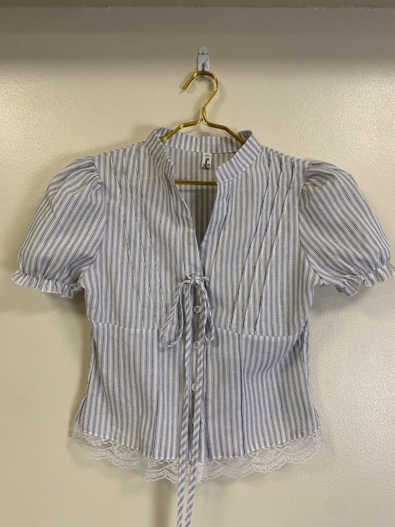Vietnam top (Category: Blouses) located in Davao. Submitted by 2ndbase.dvo.ii (Listing ID 1465854868, Image 1). Description: - Style: Blue and white pinstripe short sleeve blouse - Size: Medium (tag on collar) - Details: Mandarin collar, front button closure with decorative ties, puff sleeves with ruffled cuffs - Fit: Smocked elastic back panel for extra stretch and comfort - Accent: Lovely white lace hem detailing along the bottom - Condition: E