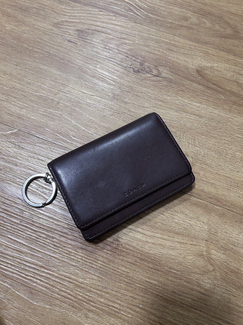 Vintage Coach Mahogany Bedford Multi-function Purse Wallet (Category: Wallets & Card holders) located in Del Monte. Submitted by antonja (Listing ID 1465861753, Image 1). Description: - 100% genuine brown leather Coach wallet - Compact size with secure snap closure - Features interior compartments and a zippered pocket - Convenient attached metal key ring on the side - Clean interior with embossed Coach branding - Condition: Minor surface marks f