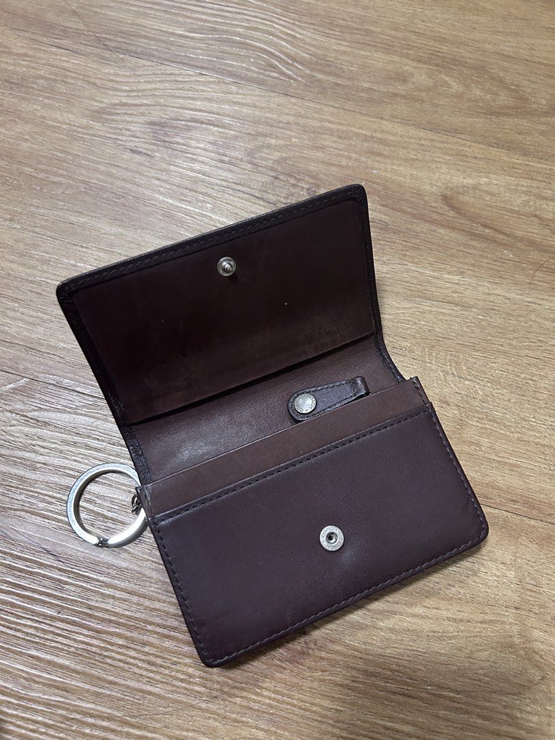 Vintage Coach Mahogany Bedford Multi-function Purse Wallet (Category: Wallets & Card holders) located in Del Monte. Submitted by antonja (Listing ID 1465861753, Image 2). Description: - 100% genuine brown leather Coach wallet - Compact size with secure snap closure - Features interior compartments and a zippered pocket - Convenient attached metal key ring on the side - Clean interior with embossed Coach branding - Condition: Minor surface marks f