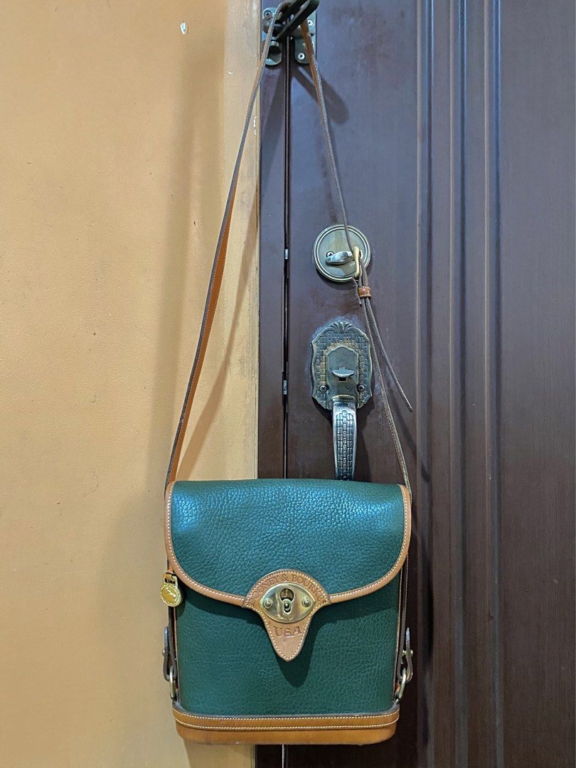 🔥Vintage Dooney & Bourke Cavalry Spectator Bag | Authentic (Category: Luxury Bags & Wallets) located in Cebu City. Submitted by kantocloset_ubec (Listing ID 1465884543, Image 1). Description: -💯Authentic Dooney & Bourke - This is a vintage bag ‘CAVALRY COLLECTION’ - Materials: Crafted using their famous textured ALL-WEATHER LEATHER - Color: Fir green w/ British tan leather trim and solid brass hardware - Near-Mint / Pristine condition - The har