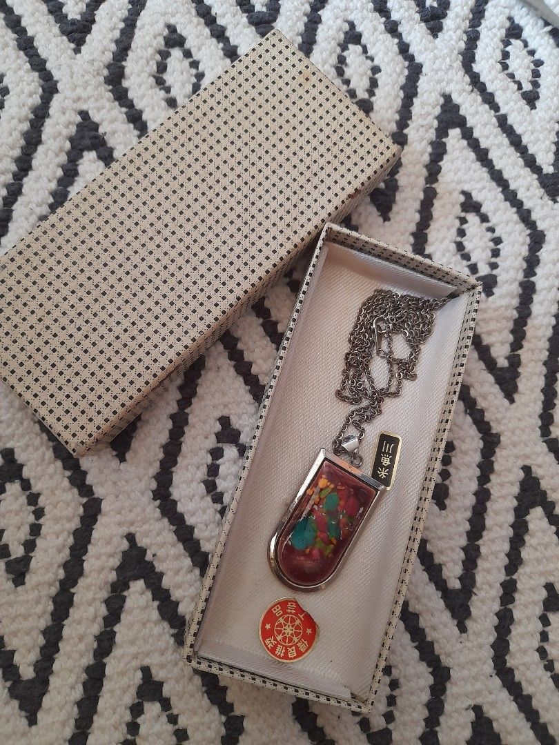 Vintage Pendant Necklace with Box (Category: Necklaces) located in Bocaue. Submitted by marajapansurplus (Listing ID 1465798639, Image 1). Description: - Silver-tone standard link chain with a secure spring-ring clasp - Eye-catching rectangular resin mosaic pendant with a rounded top edge - Polished silver-tone back finish on the pendant - Includes original patterned presentation box with a red circular emblem.