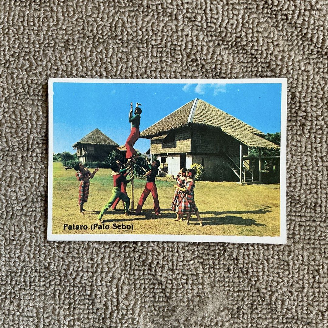 Vintage Philippines Souvenir Postcards Set (Category: Vintage Collectibles) located in Tabaco. Submitted by flosheis (Listing ID 1465808794, Image 2). Description: - Set of 5 vintage Philippine postcards - Features iconic landmarks: Manila Bay Sunset, San Juanico Bridge, Intramuros, Taal Volcano, and Palo Sebo traditional game - Colorful imagery with descriptive text on the bottom edge - Ideal for collectors, postcrossers, or cultural enthusiasts