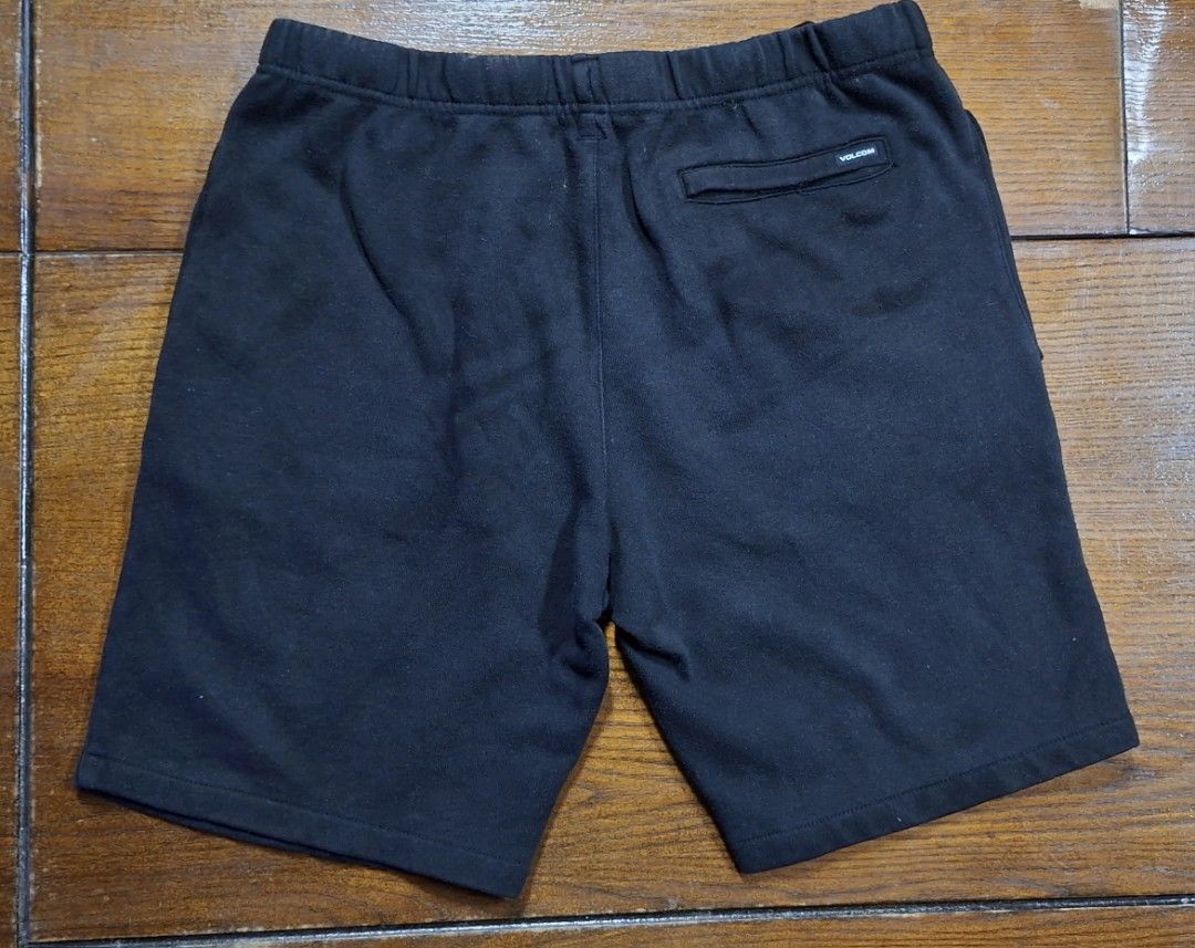 Volcom Black Sweat Shorts (Category: Shorts) located in Manila. Submitted by declutrredgoods (Listing ID 1465938621, Image 2). Description: - Brand: Volcom -Waist: 32 - 34 - Color: Classic Black - Material: Soft and comfortable cotton fleece - Fit: Elastic waistband with adjustable drawstring - Details: 3 signature stacked Volco stone logos near the left hem, 1 back pocket with brand tag - Style: Casual streetwear, ideal for lounging or skating -