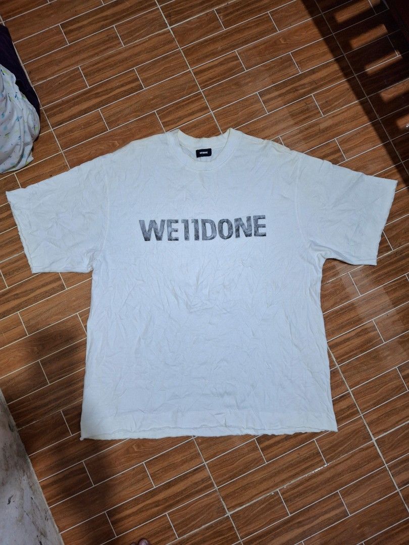 We11done SS20 Collection White T-Shirt (Category: Formal Shirts) located in Manila. Submitted by sebastianb27035 (Listing ID 1465792178, Image 2). Description: - Brand: We11done (SS20 Collection) - Color: White with iconic black stitched hem tag - Fit: Standard short sleeve crewneck - Condition: Pre-loved with slight discoloration and minor yellowish spots near the lower area - Style: Perfect addition to any streetwear fit 1200 freeship 23x30inch