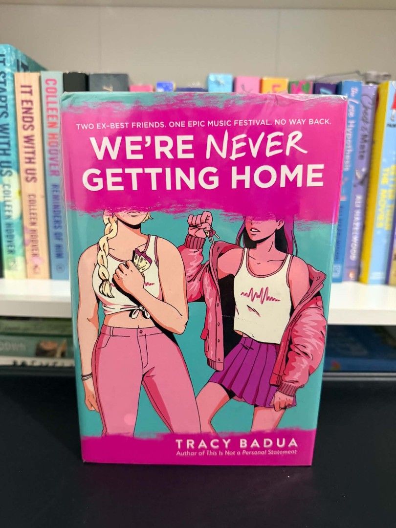 We're Never Getting Home by Tracy Badua (Category: Storybooks) located in Manila. Submitted by maggiesilang (Listing ID 1465785261, Image 1). Description: - Title: Young Adult Contemporary Fiction by Tracy Badua - Plot: Two ex-best friends reunite at a music festival - Format: Paperback edition with a vibrant pink and teal cover - Condition: Clean pages, intact spine, and minimal shelf wear along the edges.