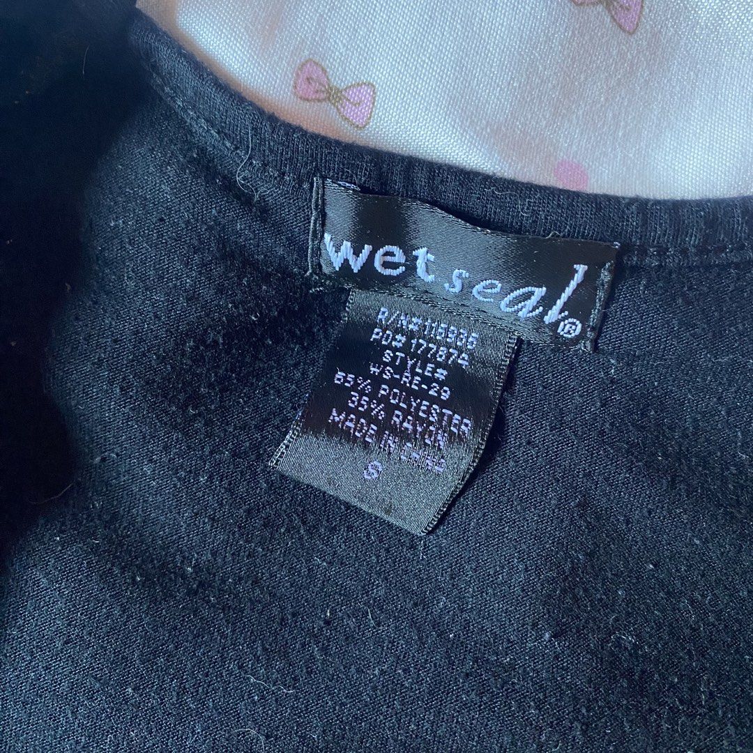 Wet Seal black wrap blouse size S (Category: Blouses) located in Abulug. Submitted by dear_darlingdoll (Listing ID 1465843529, Image 2). Description: 𐙚 a chic and timeless piece for my vintage, y2k, and minimalist fashion girlies! 🖤🎀 ♡ authentic Wet Seal ♡ size: Small (S) ♡ color: black ♡ soft fabric with a flattering fitted silhouette ♡ classic short sleeves and a simple neckline ♡ ruched waist with a long wrap-style tie detail ♡ perfect for 