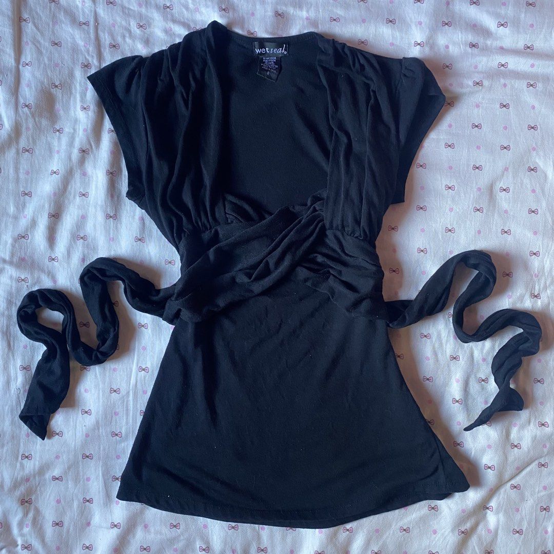 Wet Seal black wrap blouse size S (Category: Blouses) located in Abulug. Submitted by dear_darlingdoll (Listing ID 1465843529, Image 1). Description: 𐙚 a chic and timeless piece for my vintage, y2k, and minimalist fashion girlies! 🖤🎀 ♡ authentic Wet Seal ♡ size: Small (S) ♡ color: black ♡ soft fabric with a flattering fitted silhouette ♡ classic short sleeves and a simple neckline ♡ ruched waist with a long wrap-style tie detail ♡ perfect for 