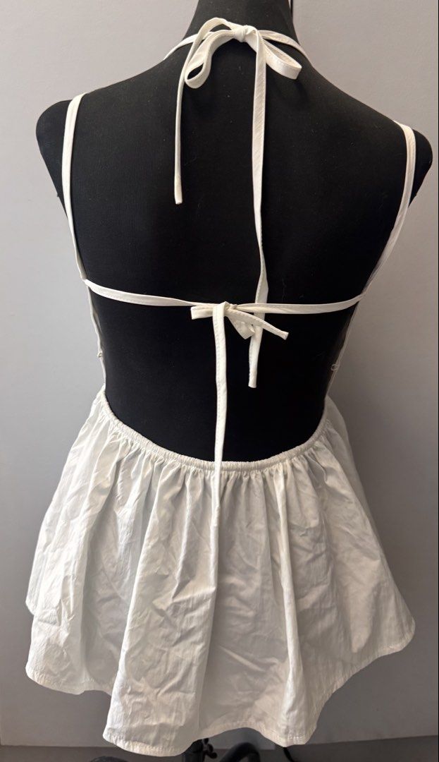 White Halter Peplum Top Backless (Category: Sleeveless) located in Dasmarinas. Submitted by pixiesell (Listing ID 1465783315, Image 2). Description: Halter top with ruffled peplum hem and open back. Size: XL as per tag, but will fit medium Never worn..