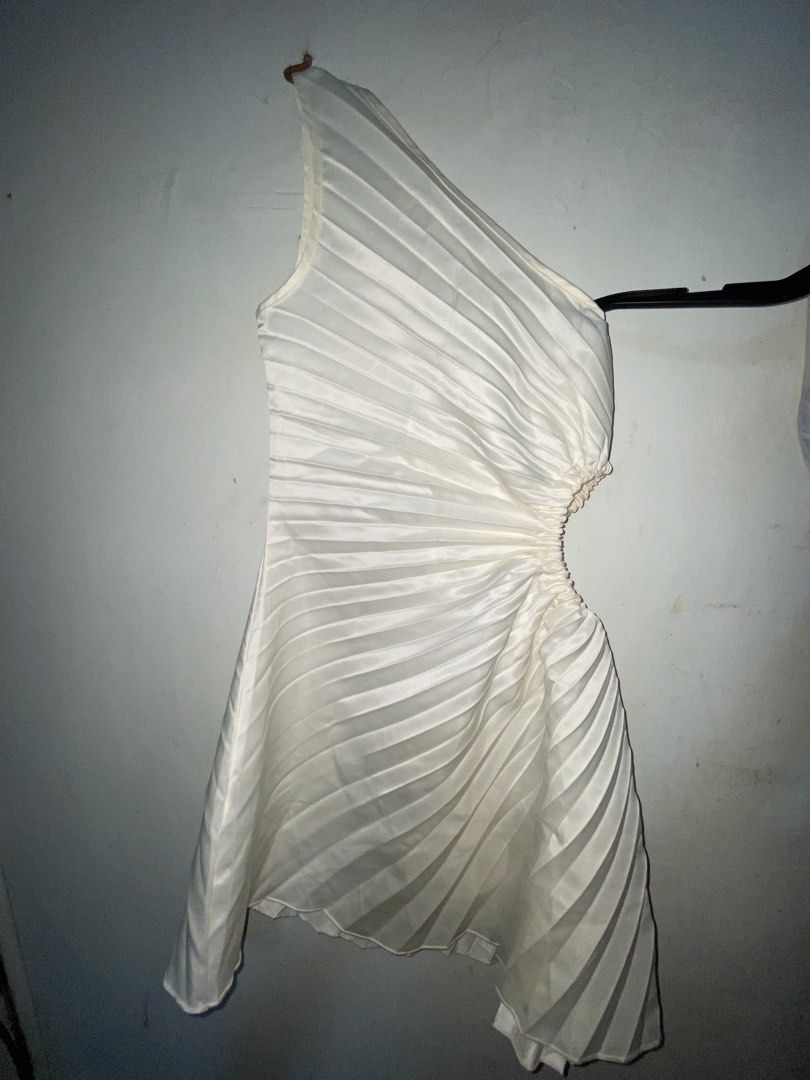 White one-shoulder pleated mini dress (Category: Dresses) located in Manila. Submitted by mauicli15 (Listing ID 1465796208, Image 1). Description: - Color: White - Design: One-shoulder style with all-over pleats - Details: Asymmetric cut at the waist with gathered detailing and a flare skirt hem - Material: Lightweight and comfortable fabric - Occasion: Ideal for parties, dates, or evening outings.