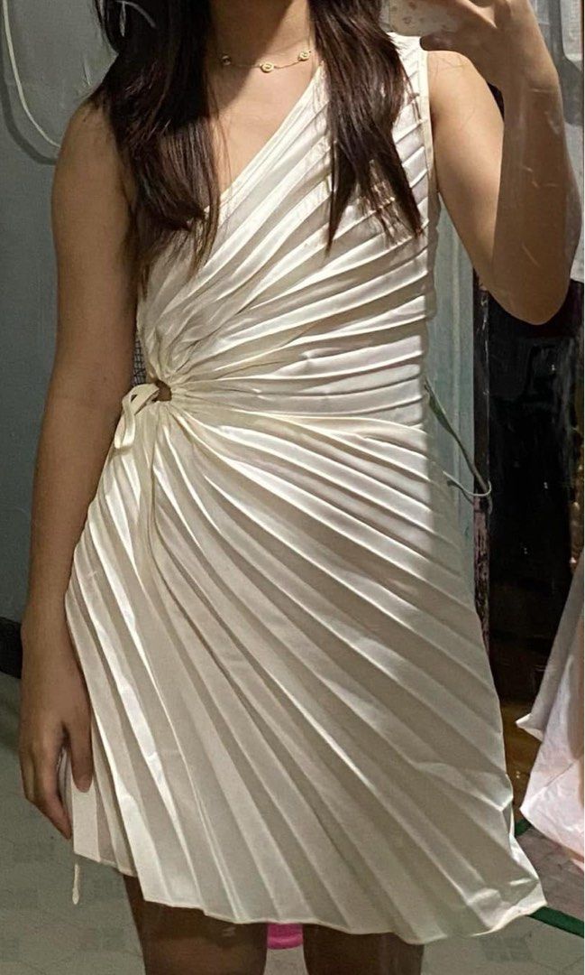 White one-shoulder pleated mini dress (Category: Dresses) located in Manila. Submitted by mauicli15 (Listing ID 1465796208, Image 3). Description: - Color: White - Design: One-shoulder style with all-over pleats - Details: Asymmetric cut at the waist with gathered detailing and a flare skirt hem - Material: Lightweight and comfortable fabric - Occasion: Ideal for parties, dates, or evening outings.