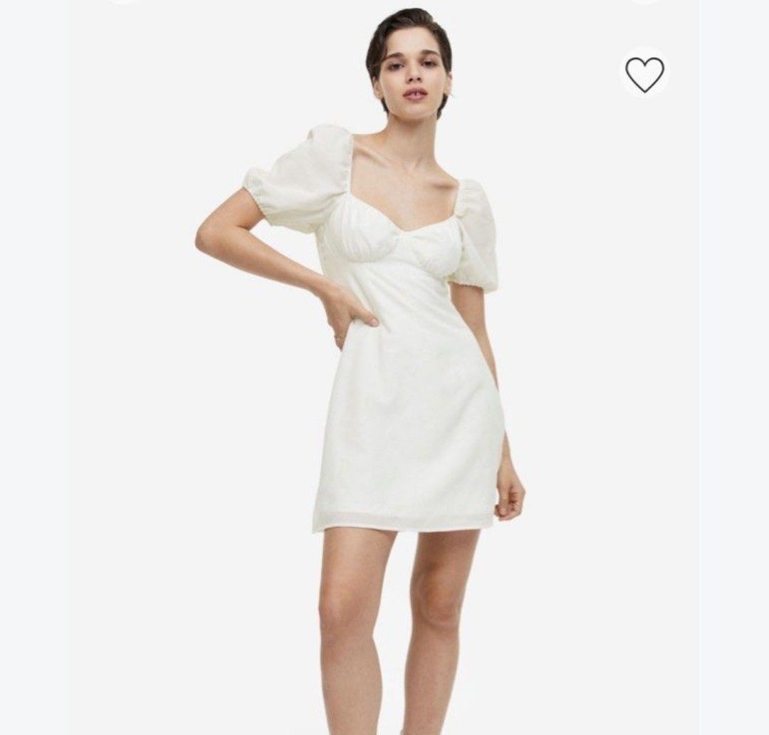 White Puff Sleeve Mini Dress (Category: Dresses) located in Cebu City. Submitted by kitty_12345_ (Listing ID 1465877960, Image 1). Description: - Brand: Sunday Classics - Color: White - Style: Mini dress with sweetheart neckline and gathered bust - Sleeves: Short puff sleeves with elastic cuffs - Back: Open back with crisscross straps and tie closure - Fabric: Lightweight and breathable - Condition: Excellent / Like new - Perfect for: Casual outi