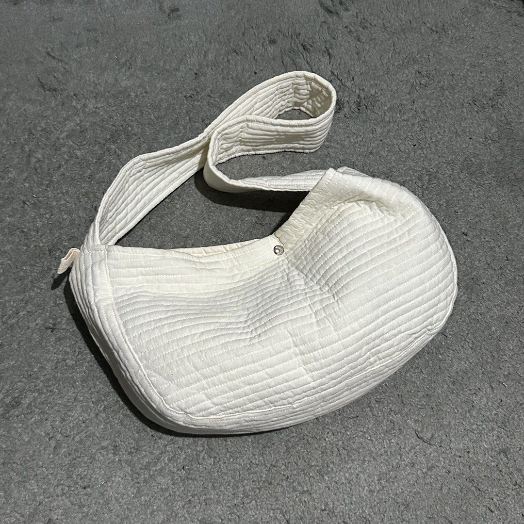 White Quilted Shoulder Bag Crescent Bag (Category: Shoulder Bags) located in Lipa City. Submitted by jecoparra (Listing ID 1465839993, Image 3). Description: - Style: Trendy curved crescent shape with stylish horizontal quilting - Color: Clean, versatile white that matches any casual outfit - Material: Soft, lightweight fabric for comfortable daily wear - Closure: Simple and secure center magnetic button - Strap: Comfortable length for effortless