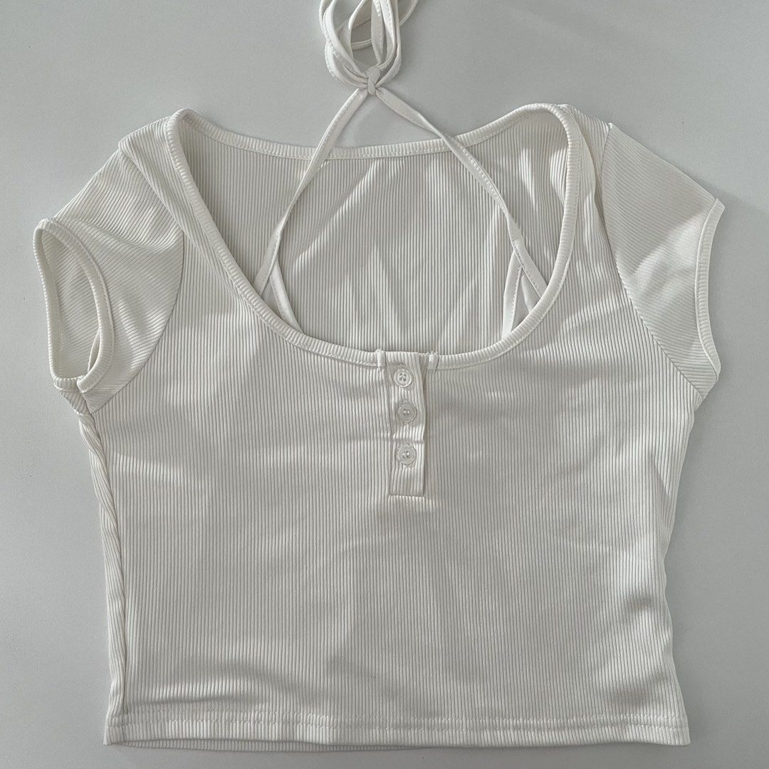 White ribbed crop top with halter straps and buttons (Category: Sleeveless) located in Cavite. Submitted by ysieunz (Listing ID 1465836211, Image 1). Description: disclaimer: all clothes are preloved but still in good-as-new condition and were only used 1–2 times. the color may vary due to lighting, but all details will be stated in the description. 📍 General Trias, Cavite 💰 GCash/Maya 🚚 JNT/SDD/Meet Up.