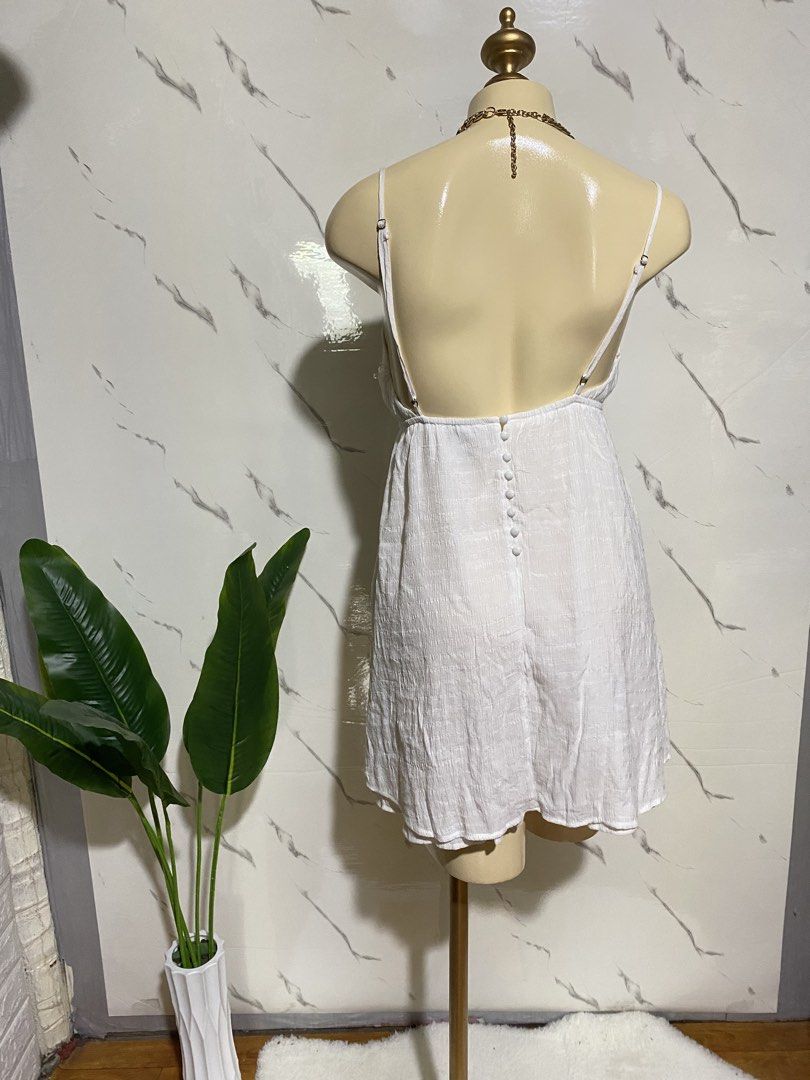 White Spaghetti Strap Mini Dress with Back Buttons (Category: Dresses) located in Taguig. Submitted by dinoswear.ph (Listing ID 1465914808, Image 3). Description: - Color: White - Style: Spaghetti strap mini dress with scoop neckline and front tie detail - Material: Lightweight textured fabric, perfect for warm weather - Back Details: Low back cut, adjustable straps, and functional button-down closure - Condition: Brand new / Excellent (ready to 